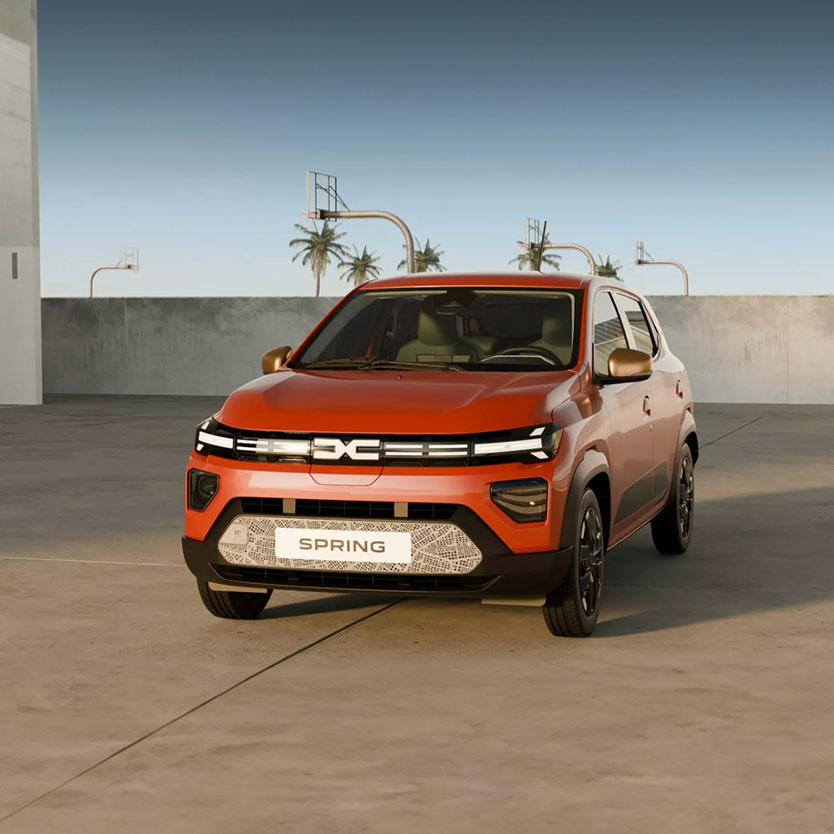 Orange Dacia Spring atop Multi-Storey Car Park