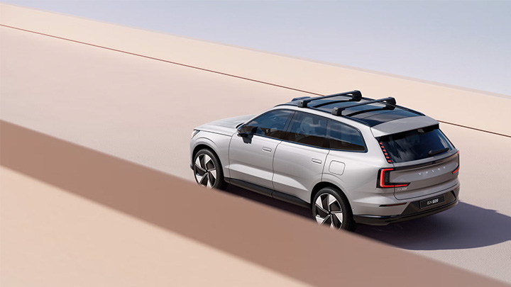 Silver Volvo EX90 Driving Exterior Rear