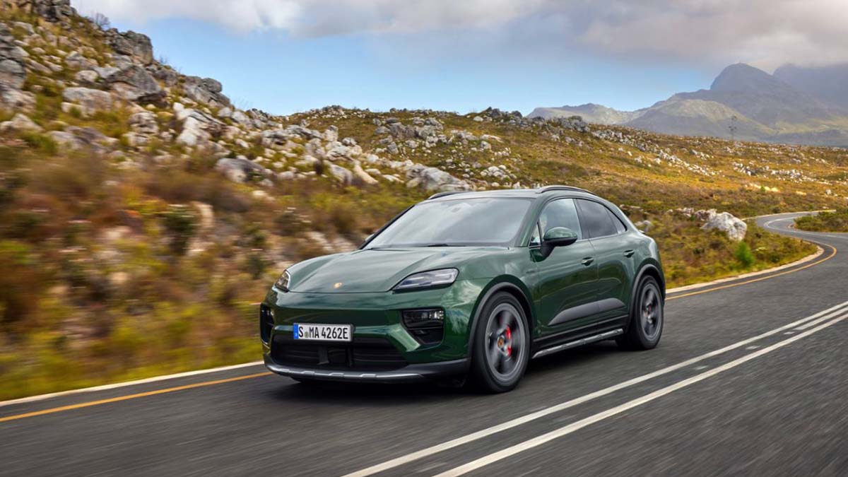 Green Porsche Macan Electric Exterior Front Driving in Mountain Range